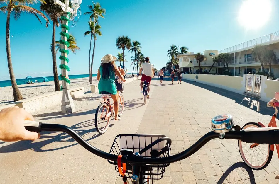 People cycling and enjoying the view of Hollywood Beach Florida