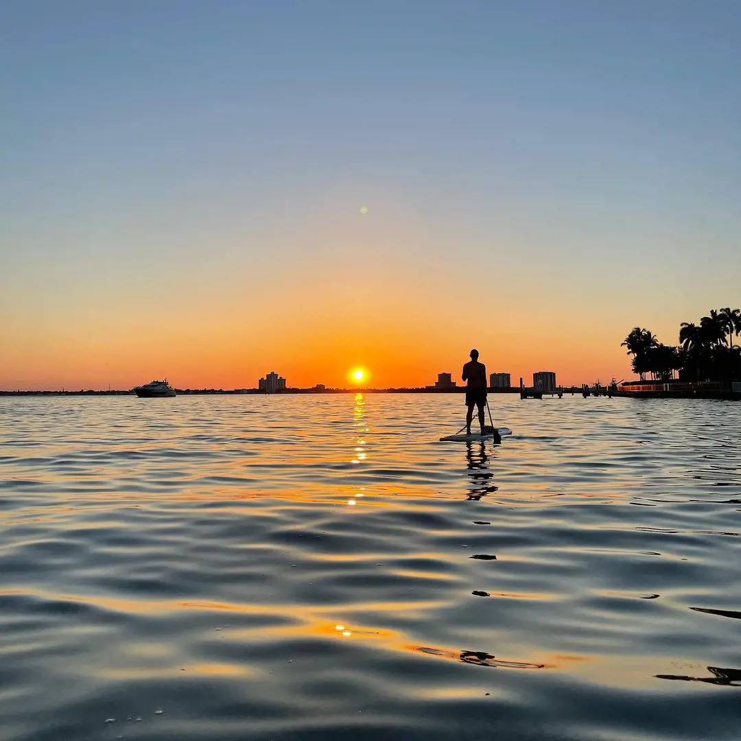 Paddleboarding while enjoying the sunset